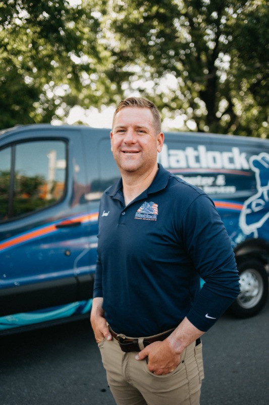 Smiling Matlock crew member in front of the wrapped van