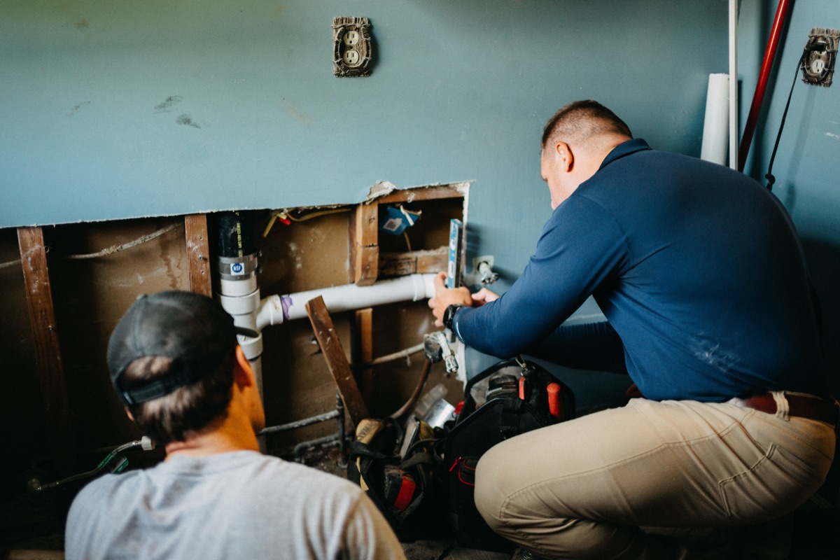 Matlock crew members working together on an interior plumbing job